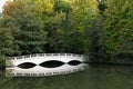 Sham white wooden bridge by lake