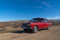 Shamakhi, Azerbaijan - January 07 2022- Red classic sedan car in a rural area