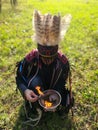 Shaman performs a ritual with the burning of grass