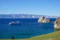 Shaman rock and cruise ship at sunset on Baikal Royalty Free Stock Photo