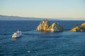 Shaman rock and cruise ship at sunset on Baikal Royalty Free Stock Photo