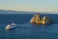 Shaman rock and cruise ship at sunset on Baikal Royalty Free Stock Photo