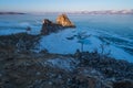 Shaman rock, holy rock of Olkhon island in a morning, Baikal frozen lake in winter, Siberia, Russia Royalty Free Stock Photo