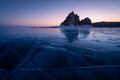 Shaman rock, sacred stone in Olkhon island in a beautiful morning sunrise, Baikal lake in winter, Russia Royalty Free Stock Photo