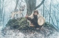 Shamanic man playing on shaman frame drum in the nature.