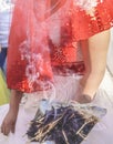 Shamanic tradition for good luck in rural Turkey. Incense of herb sticks smokes goes to young couples in a wedding ceremony