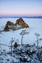 Shamanka rock in winter at sunrise. Olkhon island, Baikal lake, Siberia, Russia. Royalty Free Stock Photo