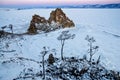 Shamanka rock in winter at sunrise. Olkhon island, Baikal lake, Siberia, Russia.