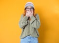 Shame. Close up beautiful young woman covering face with hands, isolated on yellow background. Oops. Ashamed girl Royalty Free Stock Photo