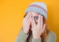 Shame. Close up young woman covering face with hands, isolated on yellow background. Oops. Ashamed girl