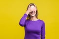 So shameful, i`d rather not watch this! Portrait of bashful positive woman covering eyes with hand.  on yellow background Royalty Free Stock Photo