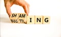 Shaming and belittling symbol. Concept words Shaming and Belittling on wooden cubes. Businessman hand. Beautiful white table white Royalty Free Stock Photo