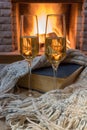 Shampagne glasses, opened book and wool scarf against cozy firepace Royalty Free Stock Photo