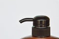 Shampoo bottle pump head press on white background