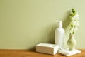 Shampoo bottle, soap, shower towel, flower on wooden table Royalty Free Stock Photo