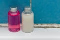 Shampoo bottles in a dirty and moldy bathroom