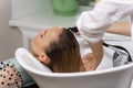 Shampooing in the beauty salon. hairdresser washes hair of a young woman before a haircut Royalty Free Stock Photo