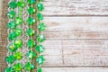 Shamrock decorations on lace burlap on wooden board Royalty Free Stock Photo