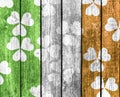 Shamrock design on wood background with Irish flag colors