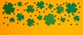 Shamrock four and three leaf clovers frame border on orange background. Happy St. Patrick`s day concept Royalty Free Stock Photo