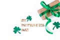 Shamrock and gift with green ribbon on a white background. Good luck symbols for St. Patrick's Day. Irish holiday. Royalty Free Stock Photo