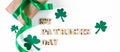 Shamrock and gift with green ribbon on a white background. Good luck symbols for St. Patrick's Day. Irish holiday. Royalty Free Stock Photo