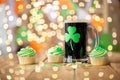 Shamrock on glass of beer, green cupcake and coins Royalty Free Stock Photo