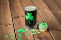 Shamrock on glass of beer, green cupcake and coins Royalty Free Stock Photo