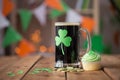 Shamrock on glass of beer, green cupcake and coins Royalty Free Stock Photo