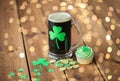 Shamrock on glass of beer, green cupcake and coins Royalty Free Stock Photo