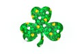 Shamrock silhouette with green orange and white confetti on white background