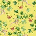 Shamrock watercolor seamless pattern isolated on beige background. Hand painted green four leaves. Hand drawn bird and