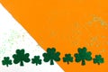 Shamrocks pattern on white and orange background. Patrick Day symbols on Ireland flag background.