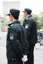 SHANGHAI, CHINA - April 2018: Two security guards wait at the gate of living complex