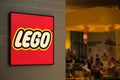 Close up LEGO store sign and blur customers