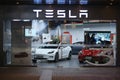 Facade of Tesla retail store at night