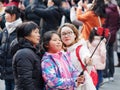 Shanghai, China - Jan. 26, 2019: Lantern Festival in the Chinese New Year Pig year, happy family take selfie in crowded people.