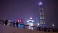 Shanghai, China - January 15, 2018: People walk along the embankment of Vaitan at the night. The Bund or Waitan is a