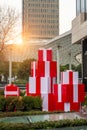A pile of red big gift boxes in front of modern architecture