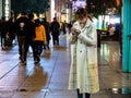 SHANGHAI, CHINA - 12 MAR 2019 Ã¢â¬âAttractive Asian Chinese lady on her smartphone at East Nanjing Road Nanjing Dong Lu pedestrian