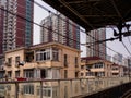 SHANGHAI, CHINA - 11 MAR 2019 - Old apartment blocks in downtown Shanghai next to train station with new high-rise flats in the