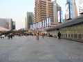 People walking near Ping Finance Building in front of Oriental Pearl Tower, Lujiazui, Pudong, Shanghai, China