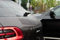 Shanghai, China, March 10, 2024: Porsche Macan SUV on city street. Back view of Porsche Macan in the traffic jam. Porsche logo on