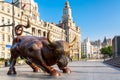 Shanghai, China - May, 2019: Bronze bull on The Bund in Shanghai, Iron bull statue in front of Chinese banks on the Waitan Bund