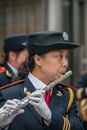 Closeup of woman in marching band blowing her long flute, Shanghai, China