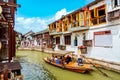 Shanghai, China - May, 2019: China traditional tourist boat on canal of Shanghai Zhujiajiao Old Town in Shanghai, China during