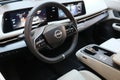 interior of Nissan electric car and logo on steering wheel