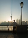 A man meditates on the Bund as the sun rises Royalty Free Stock Photo