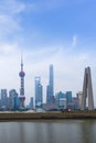 Shanghai high rises office and towers of the Business district skyline at mist behind a pollution haze, across Huangpu river,