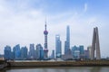 Shanghai high rises office and towers of the Business district skyline at mist behind a pollution haze, across Huangpu river,